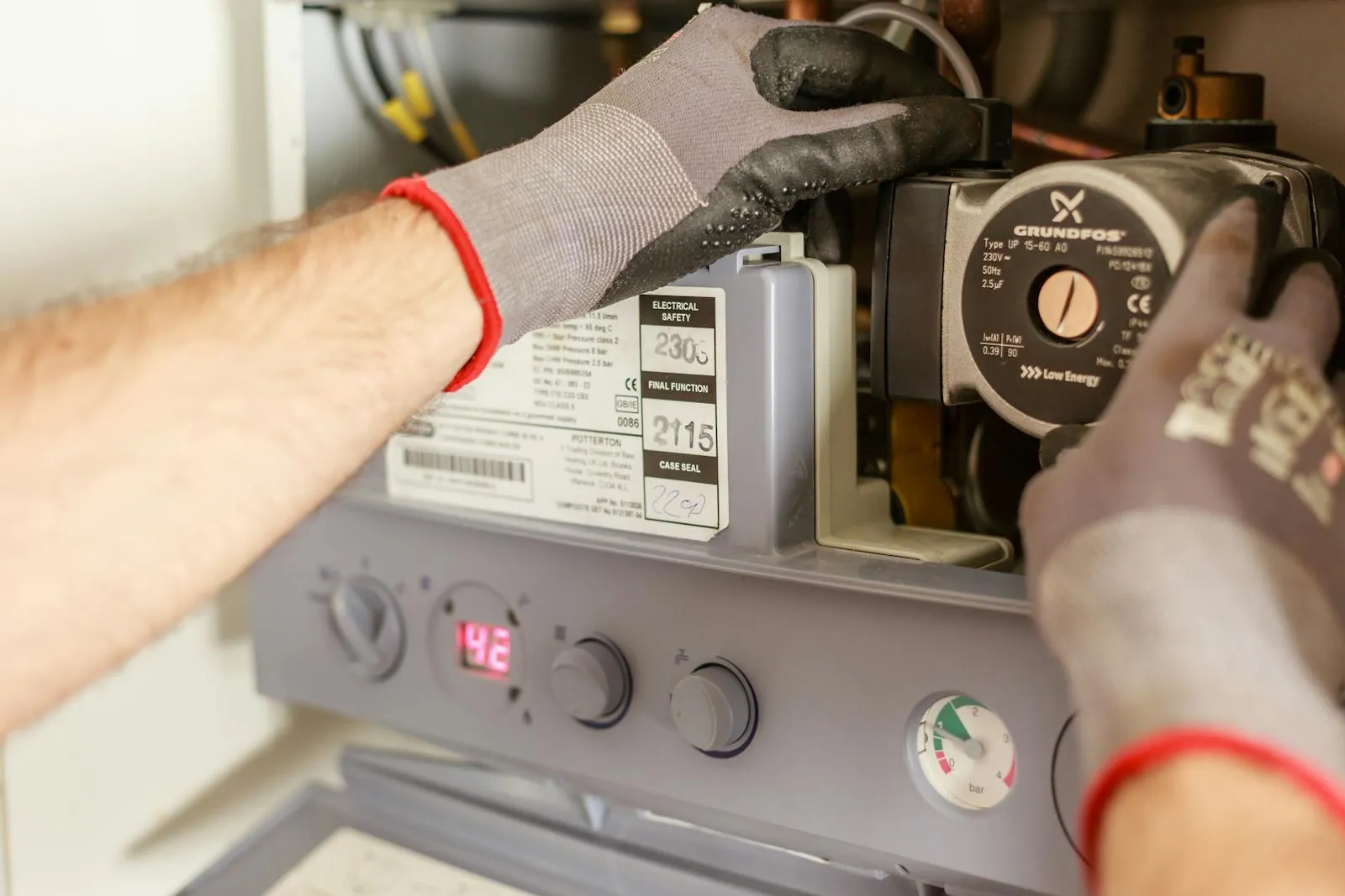 Engineer servicing a domestic boiler in a London home