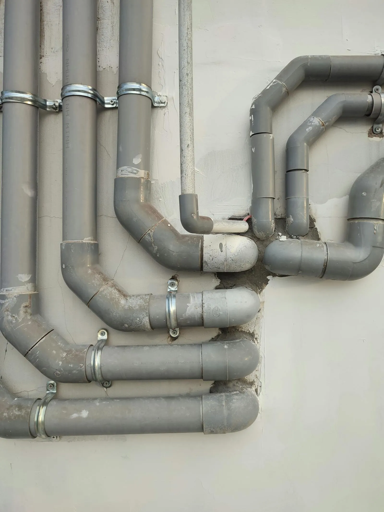 Commercial pipework on a property wall, the kind we maintain for landlords